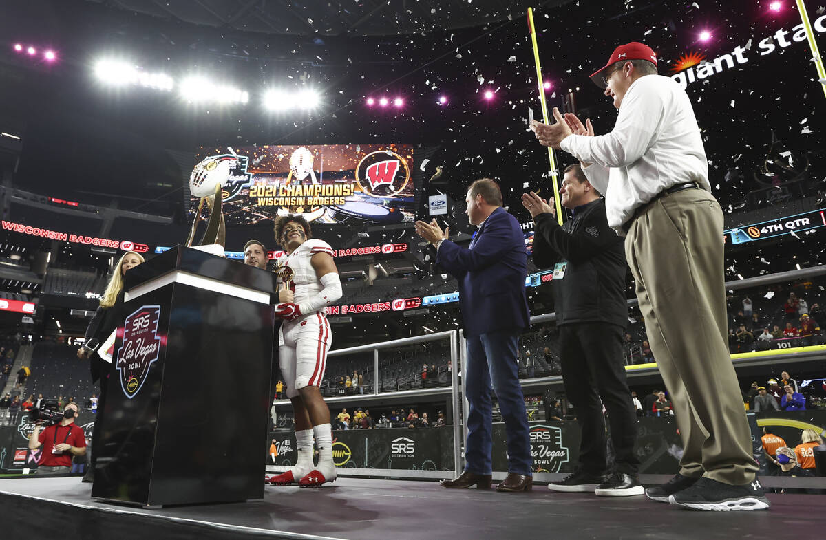 Wisconsin Badgers running back Braelon Allen, left, is named MVP as head coach Paul Chryst, rig ...