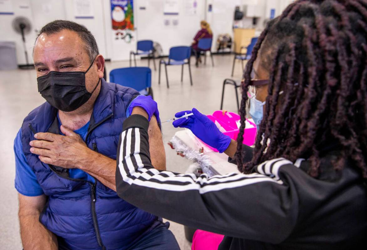 Jose Grajeda, left, is given a shot by Adwoa Fosu in the COVID-19 vaccination clinic at the Sou ...