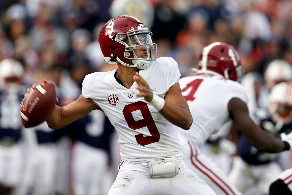 Alabama quarterback Bryce Young (9) throws a pass against Auburn during the first half of an NC ...