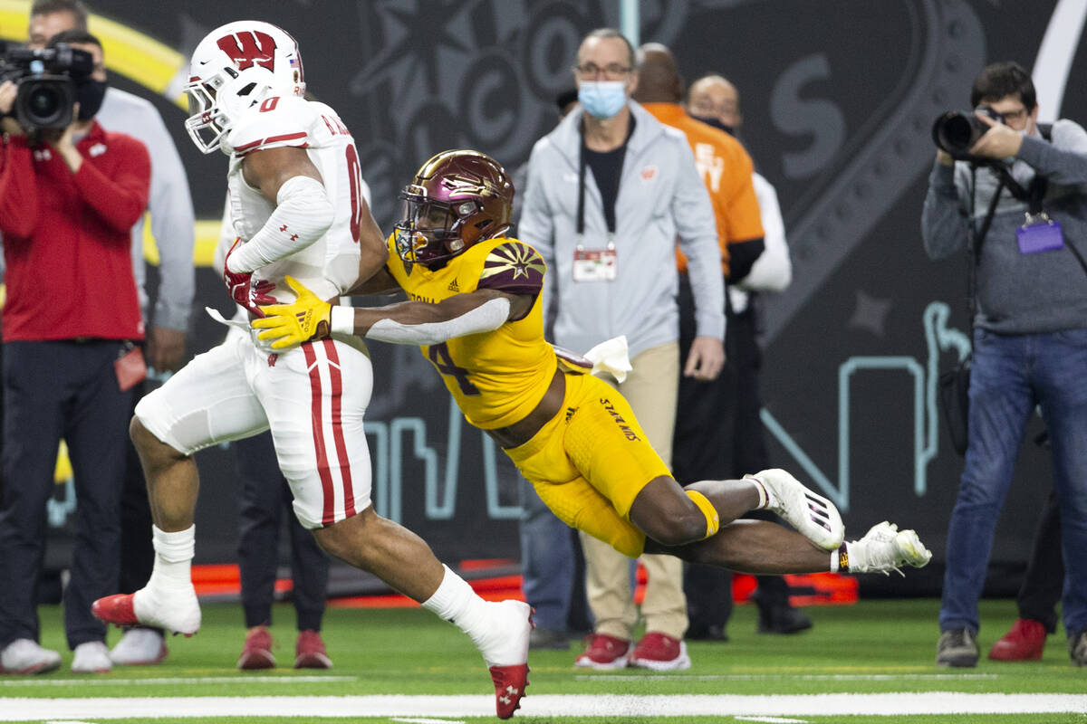 Arizona State Sun Devils defensive back Evan Fields (4) jumps to tackle Wisconsin Badgers runni ...