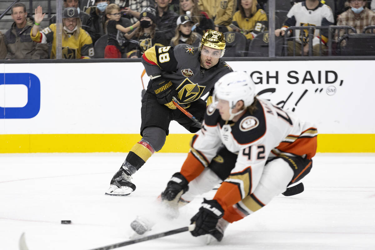 Golden Knights left wing William Carrier (28) passes while Ducks defenseman Josh Manson (42) re ...