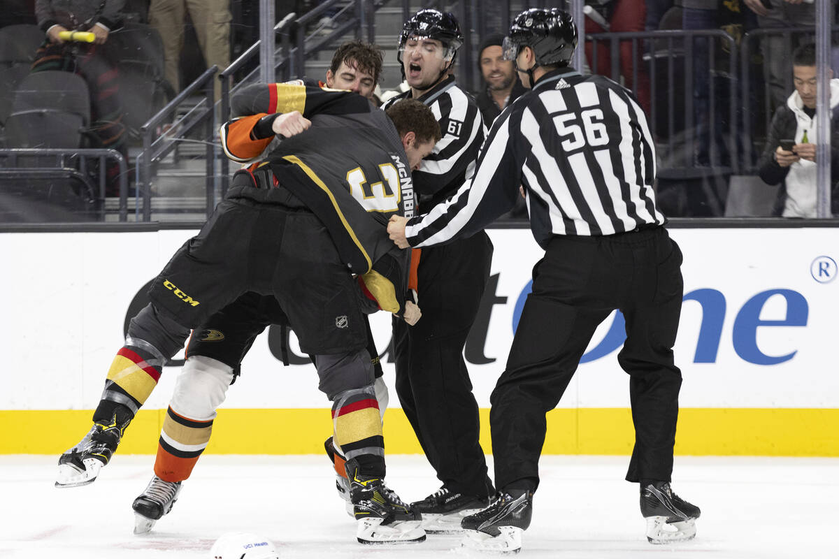 Ducks center Derek Grant (38) and Golden Knights defenseman Brayden McNabb (3) fight while refe ...