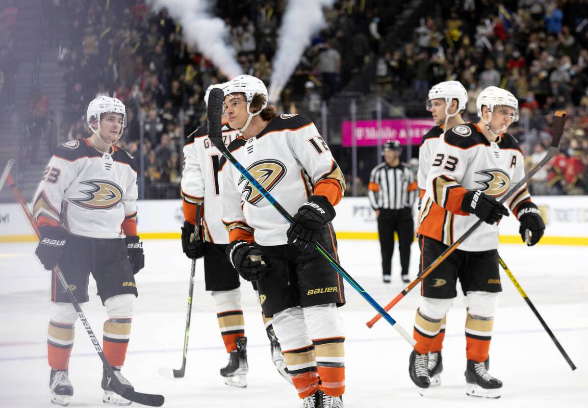 Ducks players including left wing Sonny Milano, center, skate off the ice after losing to the G ...