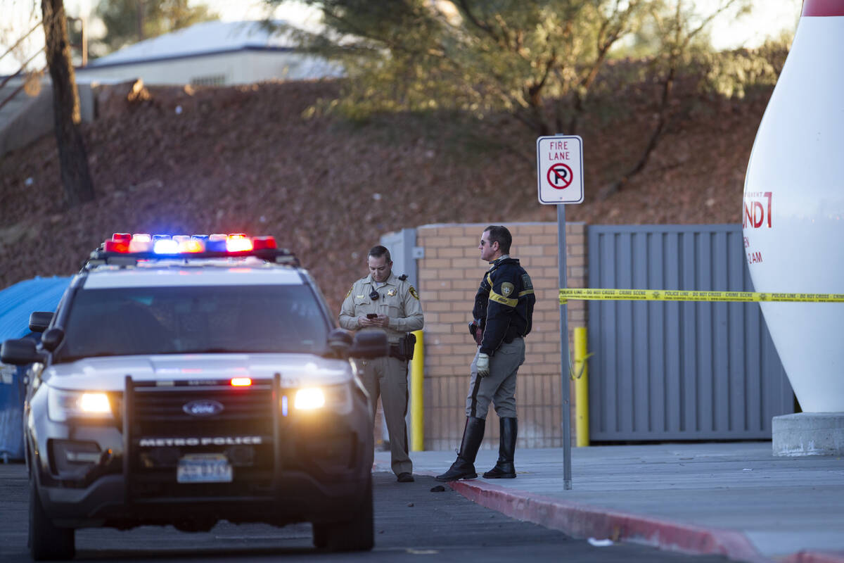 Las Vegas police officers investigate the scene of a shooting at Meadows Mall in Las Vegas, Fri ...
