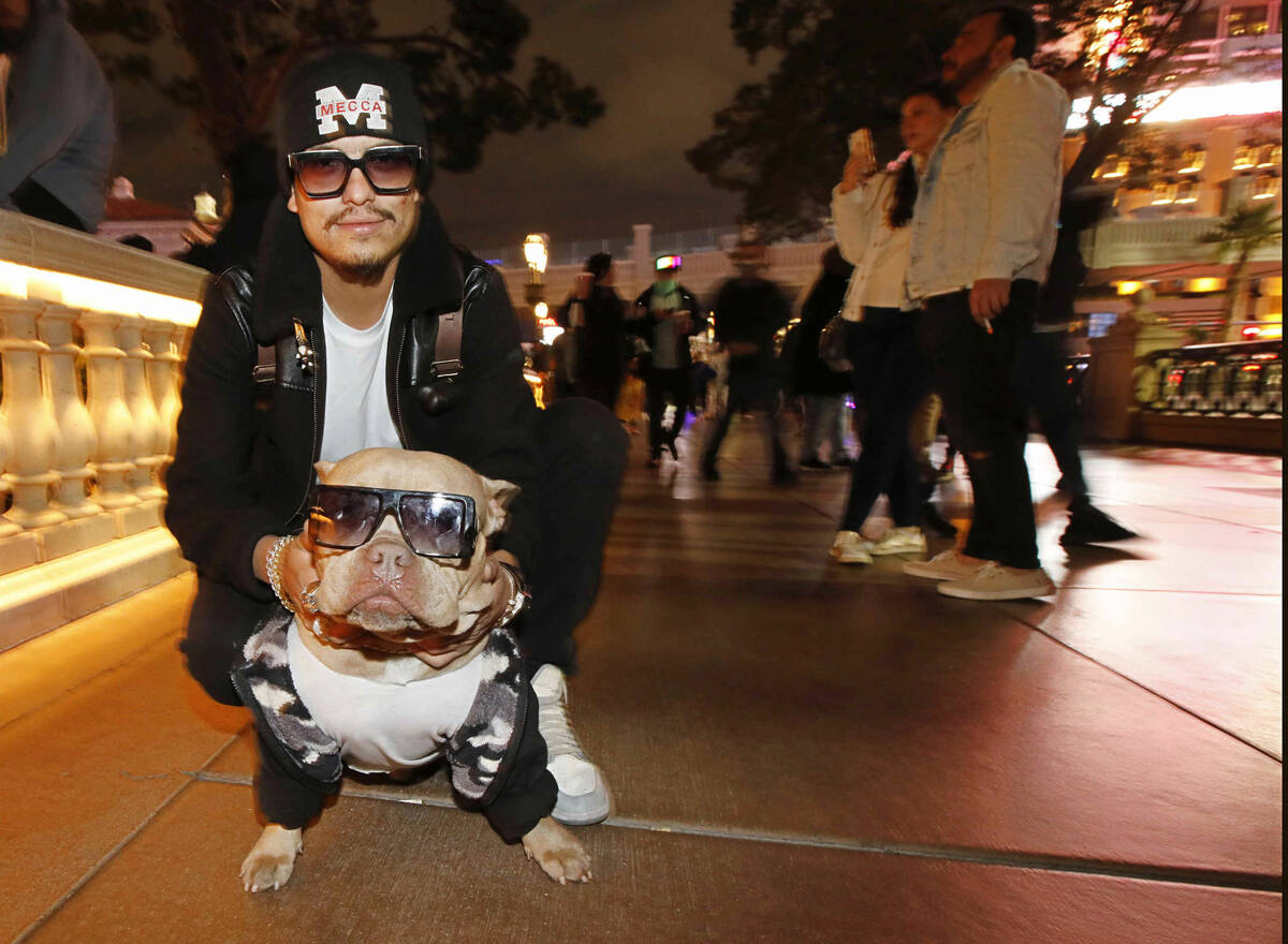Oscar Sanchez of Mecca Calif. poses for a photo with his dog Kash in front of the fountains of ...