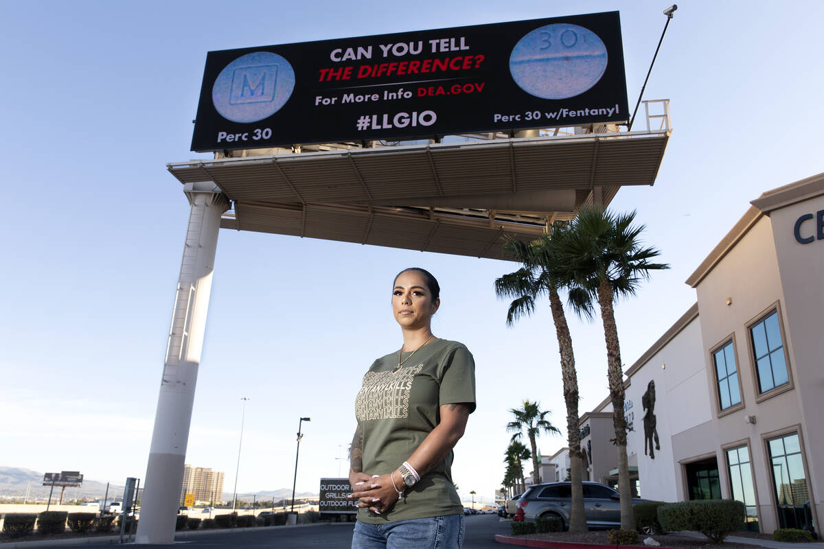Cristina Perkins, mother of Giovanni Perkins, below a billboard she funded in honor of her son ...