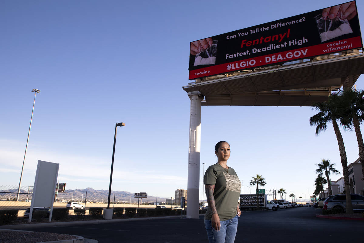 Cristina Perkins, mother of Giovanni Perkins, below a billboard she funded in honor of her son ...