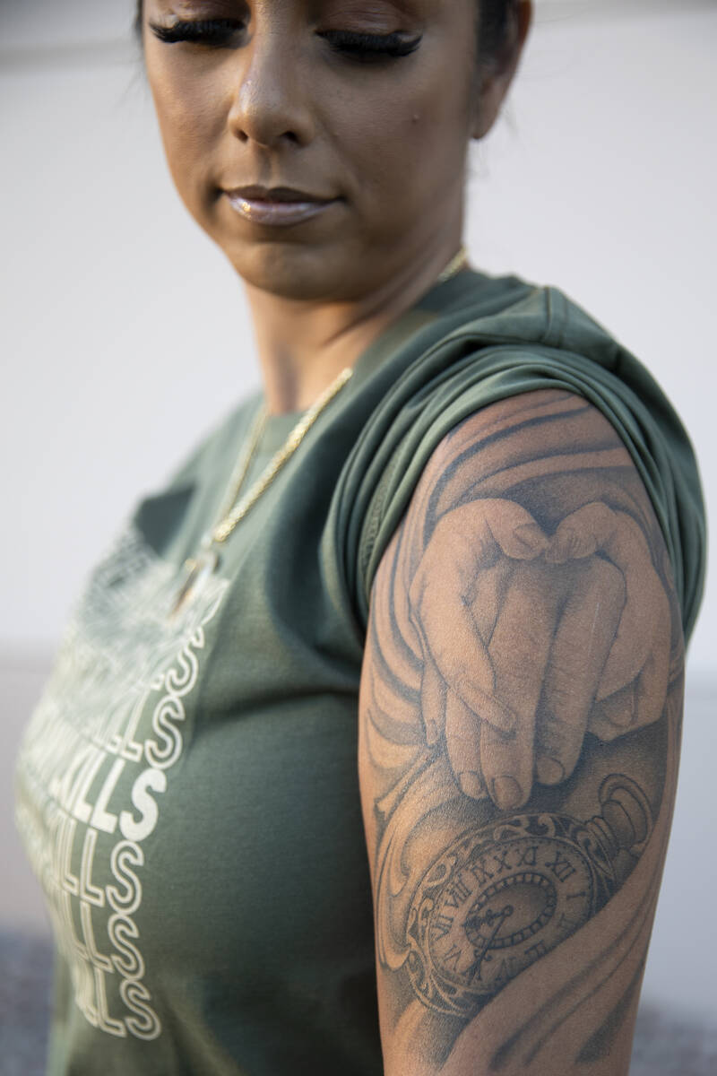 Cristina Perkins, mother of Giovanni Perkins, shows the tattoo sleeve she got in honor of her s ...