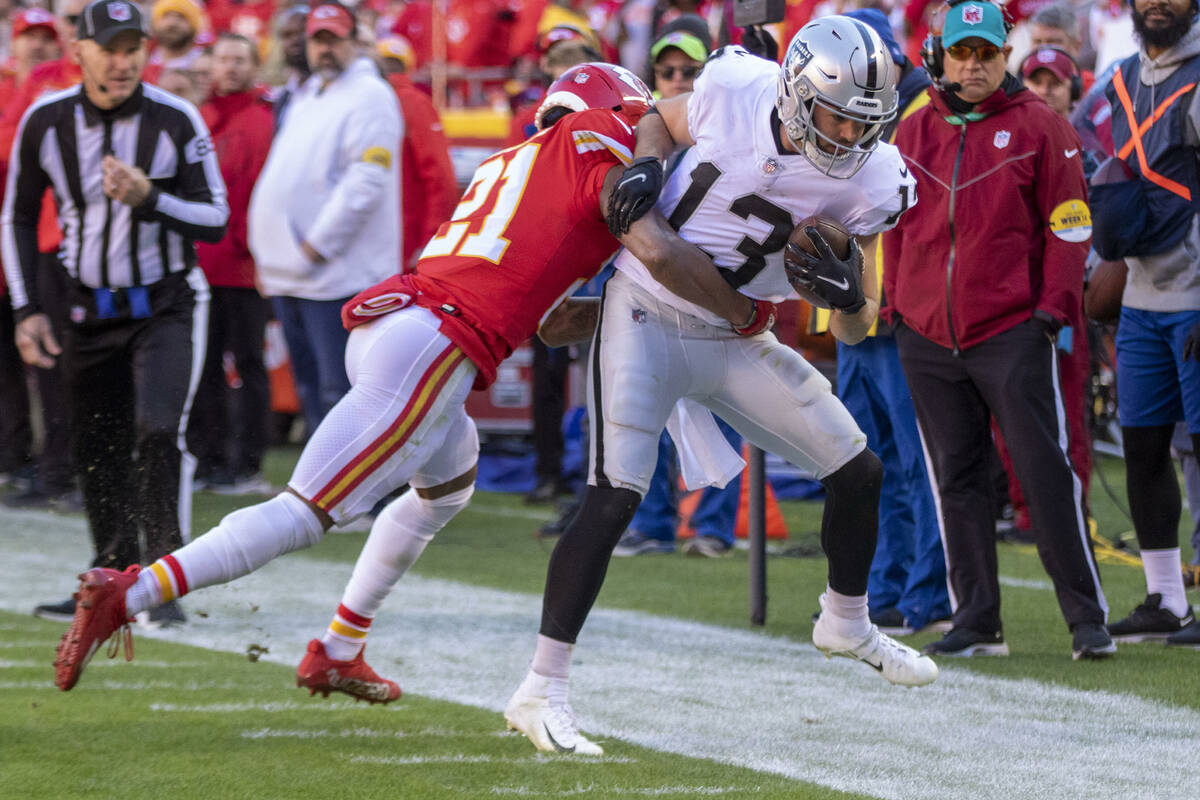 Raiders wide receiver Hunter Renfrow (13) is forced out of bounds by Kansas City Chiefs cornerb ...