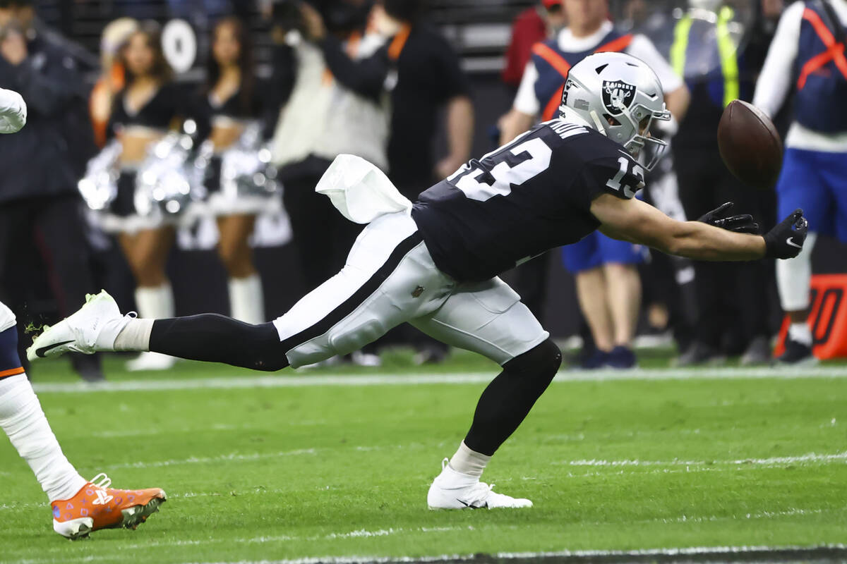 Raiders wide receiver Hunter Renfrow (13) reaches out to make the catch against the Denver Bron ...
