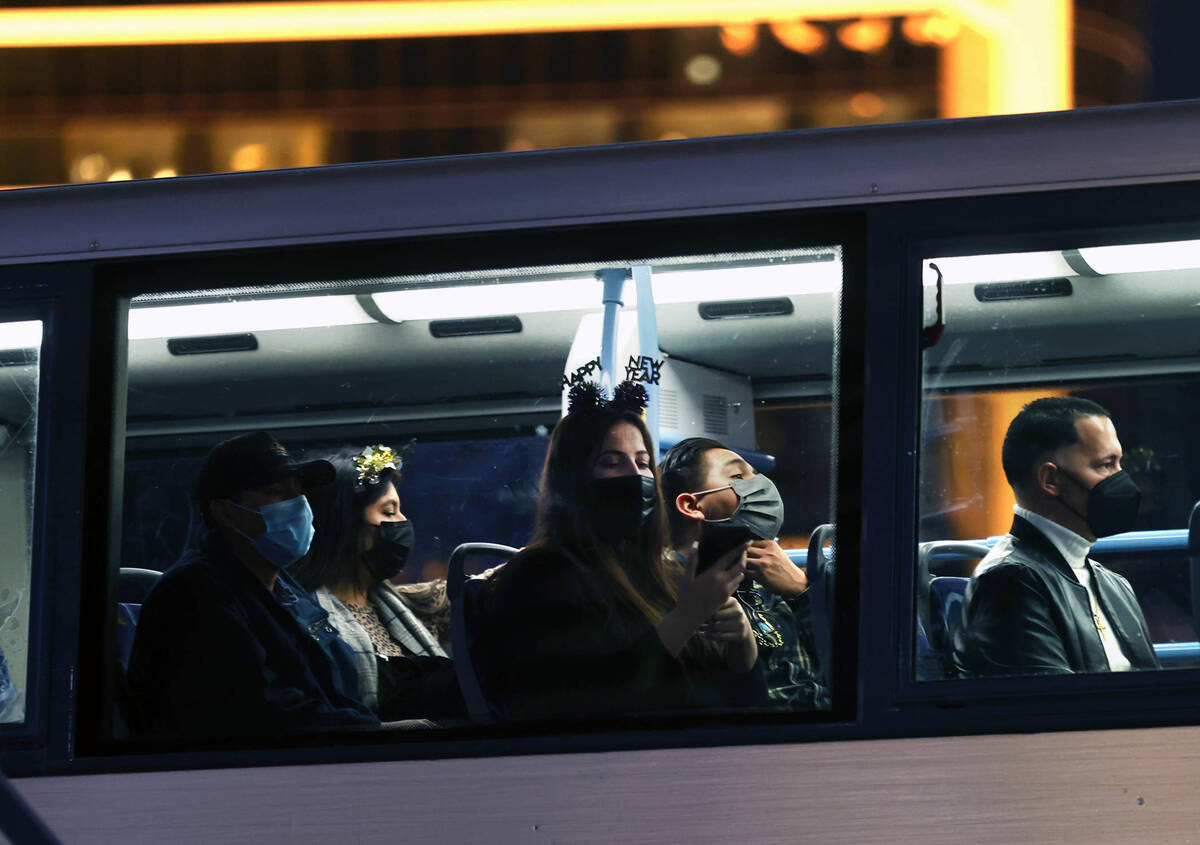 People ride an RTC bus dressed for celebrating along the Strip for New Year’s Eve on Fri ...