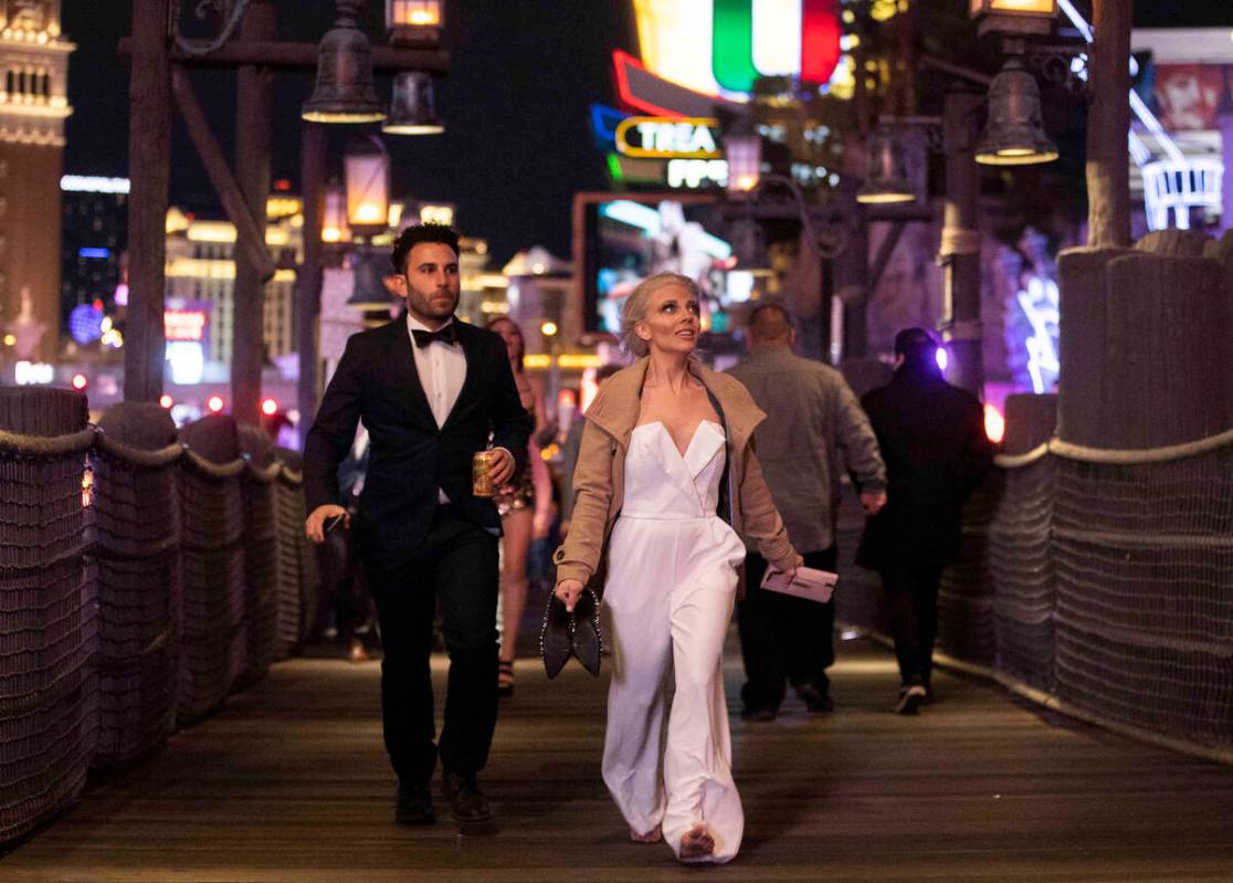 New Year’s Eve crowds walk the Strip on Friday, Dec. 31, 2021, in Las Vegas.(Benjamin Ha ...