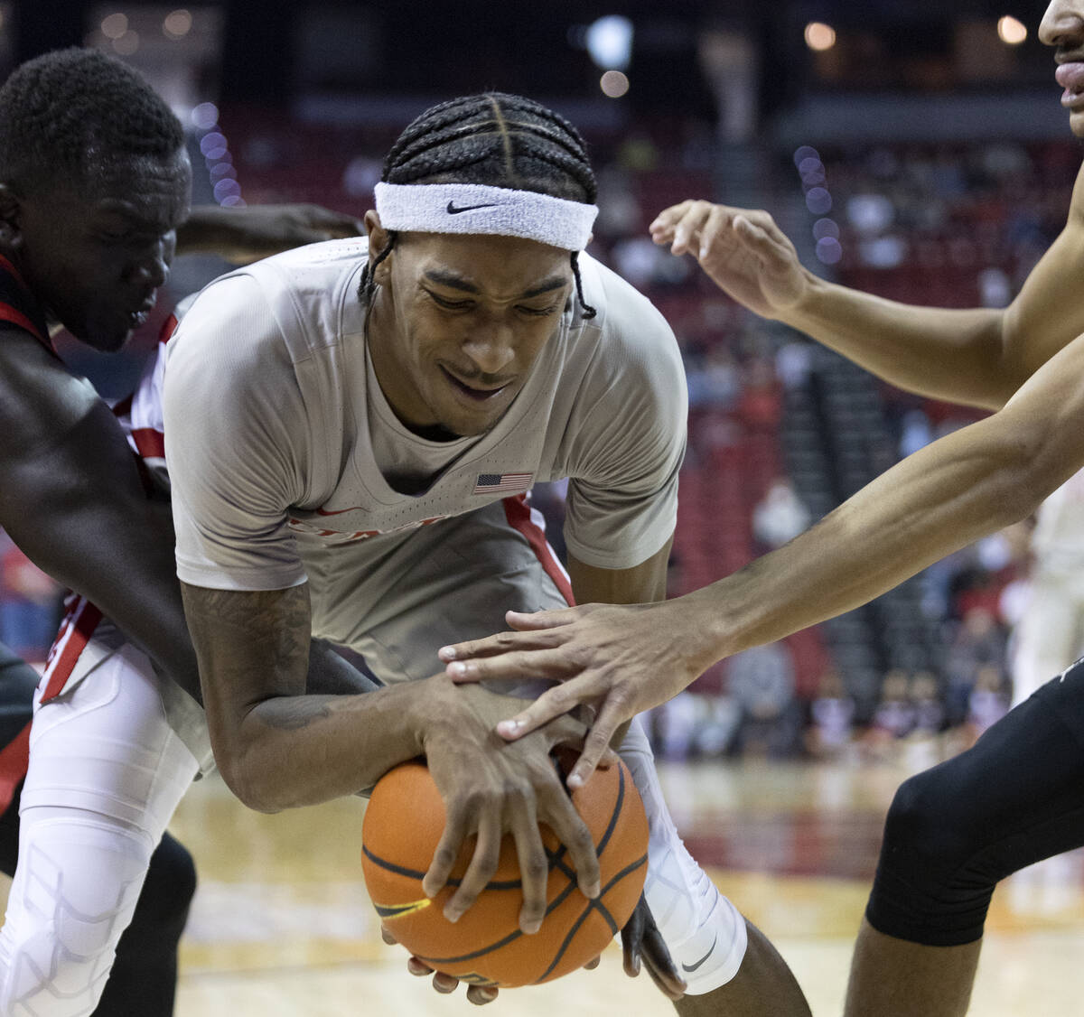 UNLV Rebels forward Donovan Williams, center, fights for the ball with San Diego State Aztecs f ...