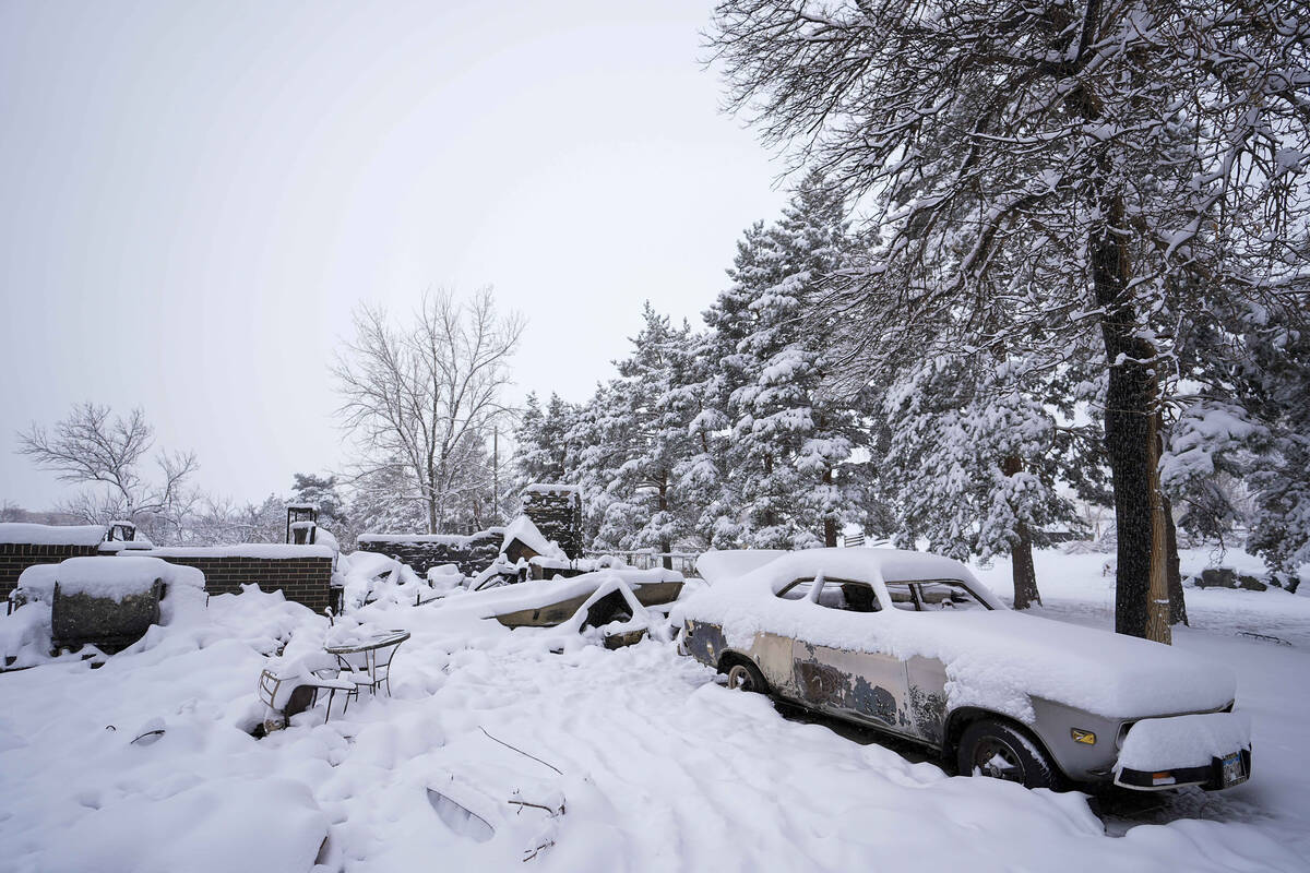 Snow covers the burned remains of a home after the Marshall Wildfire Saturday, Jan. 1, 2022, in ...