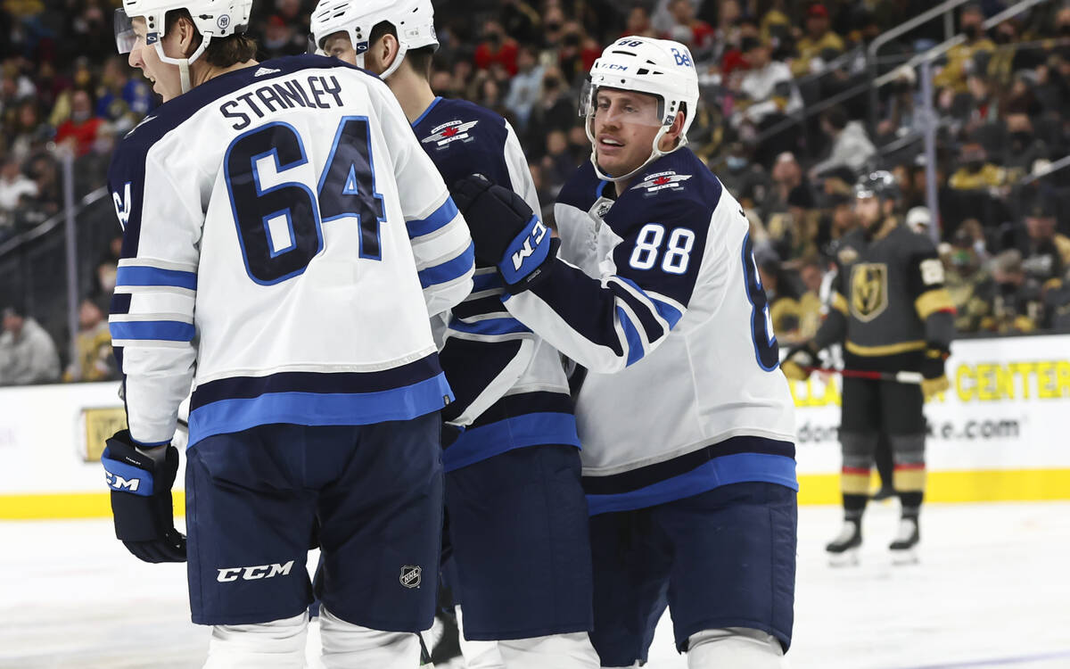 Winnipeg Jets defenseman Nate Schmidt (88) with his teammates after a Jets goal against the Gol ...