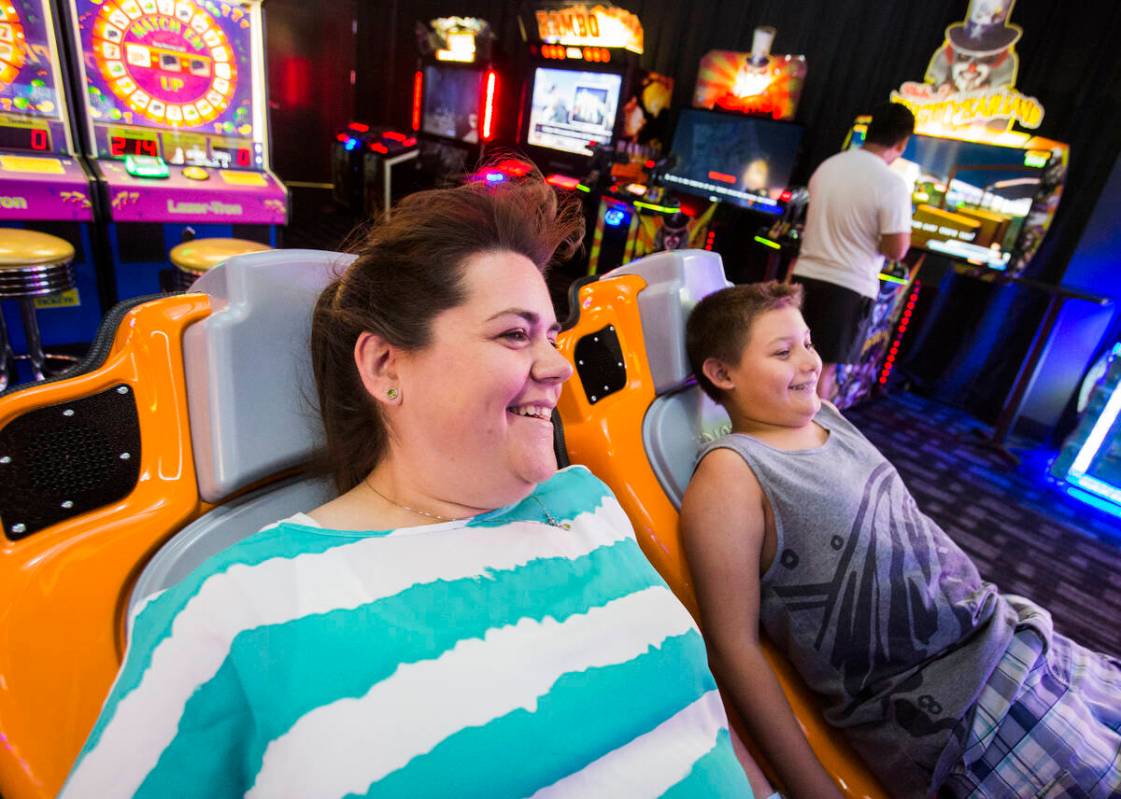 Amanda Pierce, left, and her son Austin play Typhon video game at Dave & Buster's in Downtown S ...