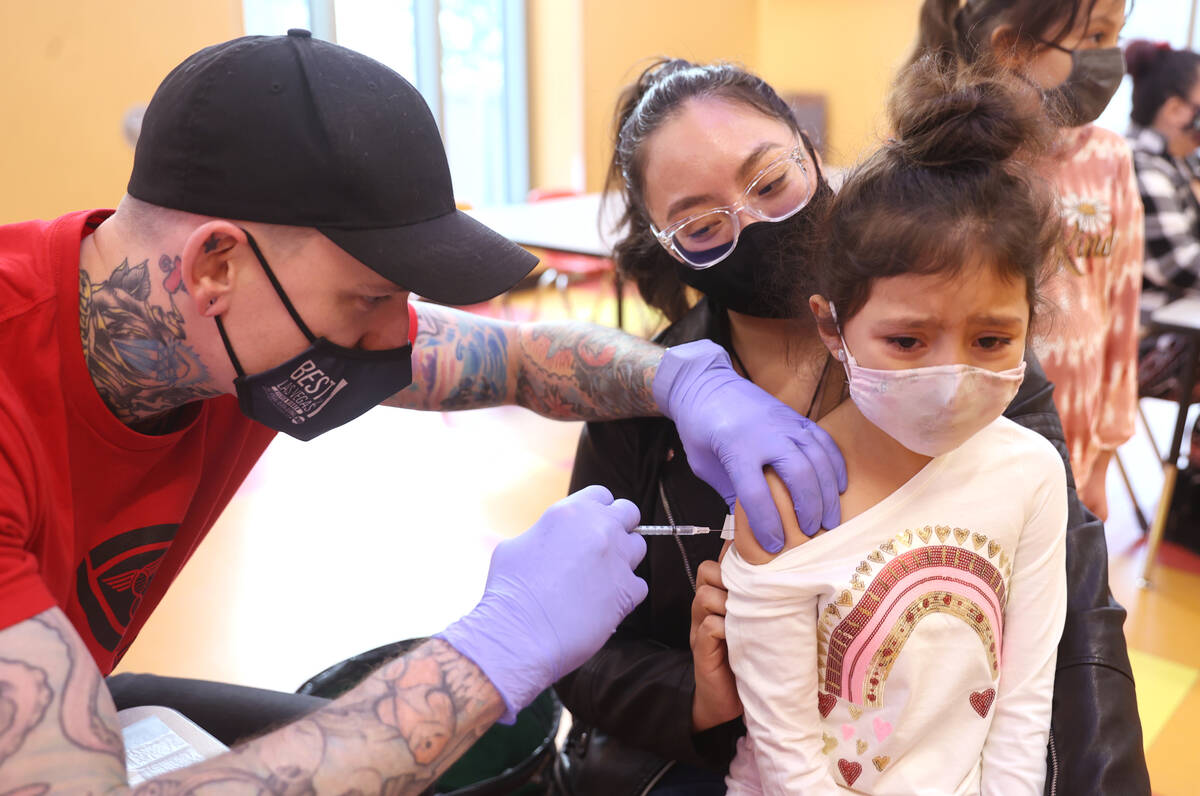 Jazlyn Urias, 6, sits with her mother Raquel Lopez while getting a COVID-19 vaccination from Gr ...