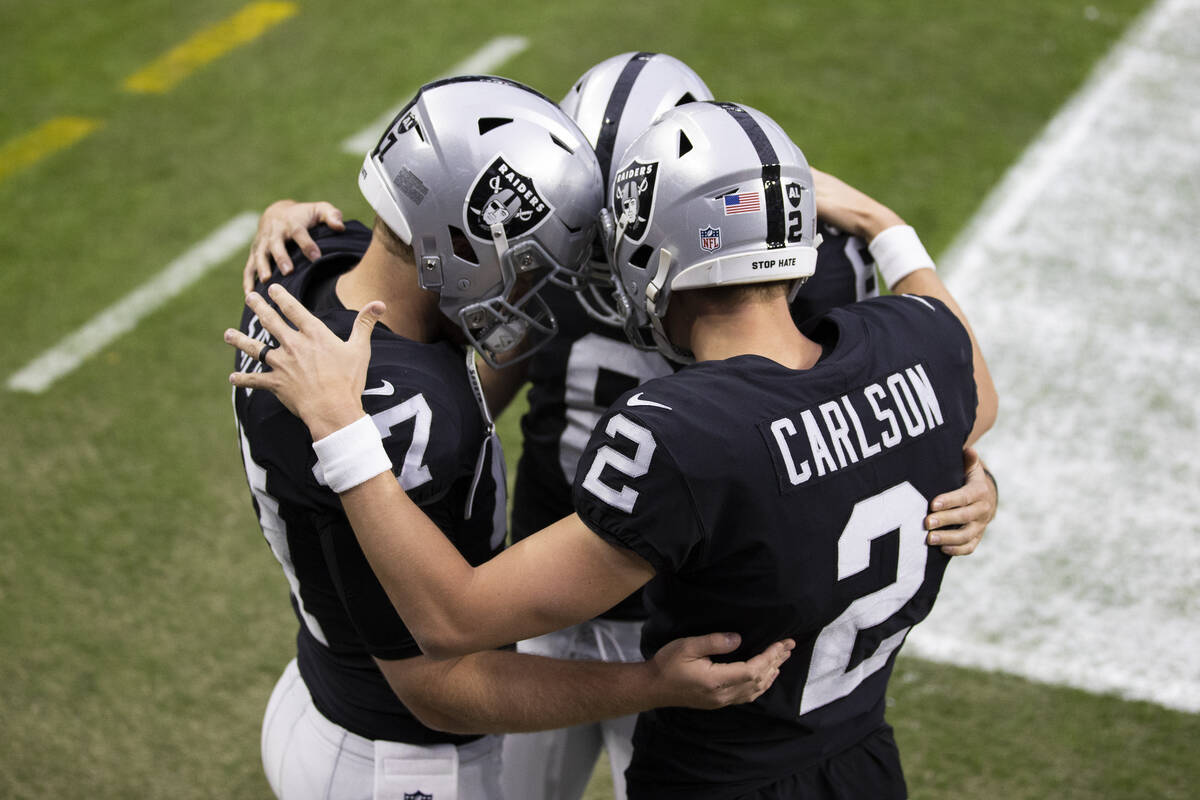 Raiders long snapper Trent Sieg (47) and Raiders kicker Daniel Carlson (2) pray before the star ...