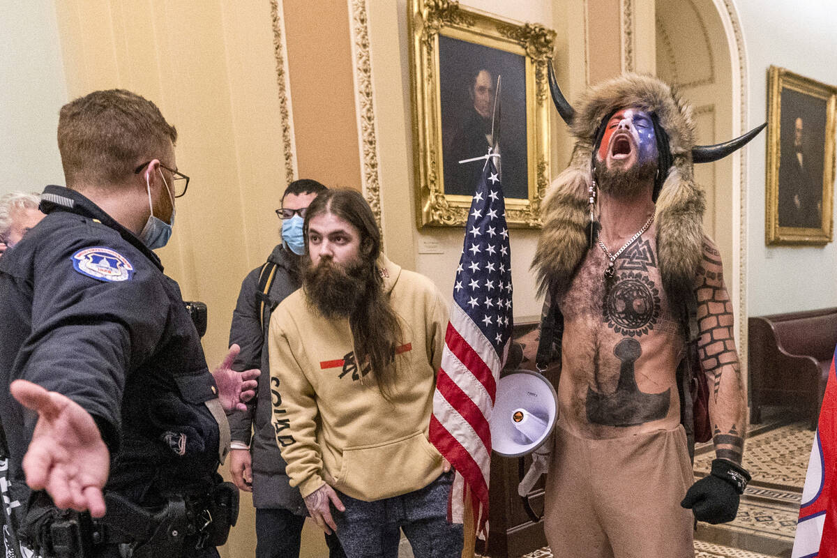 Jacob Chansley, right with fur hat, is seen during the Capitol riot in Washington, Jan. 6, 2021 ...