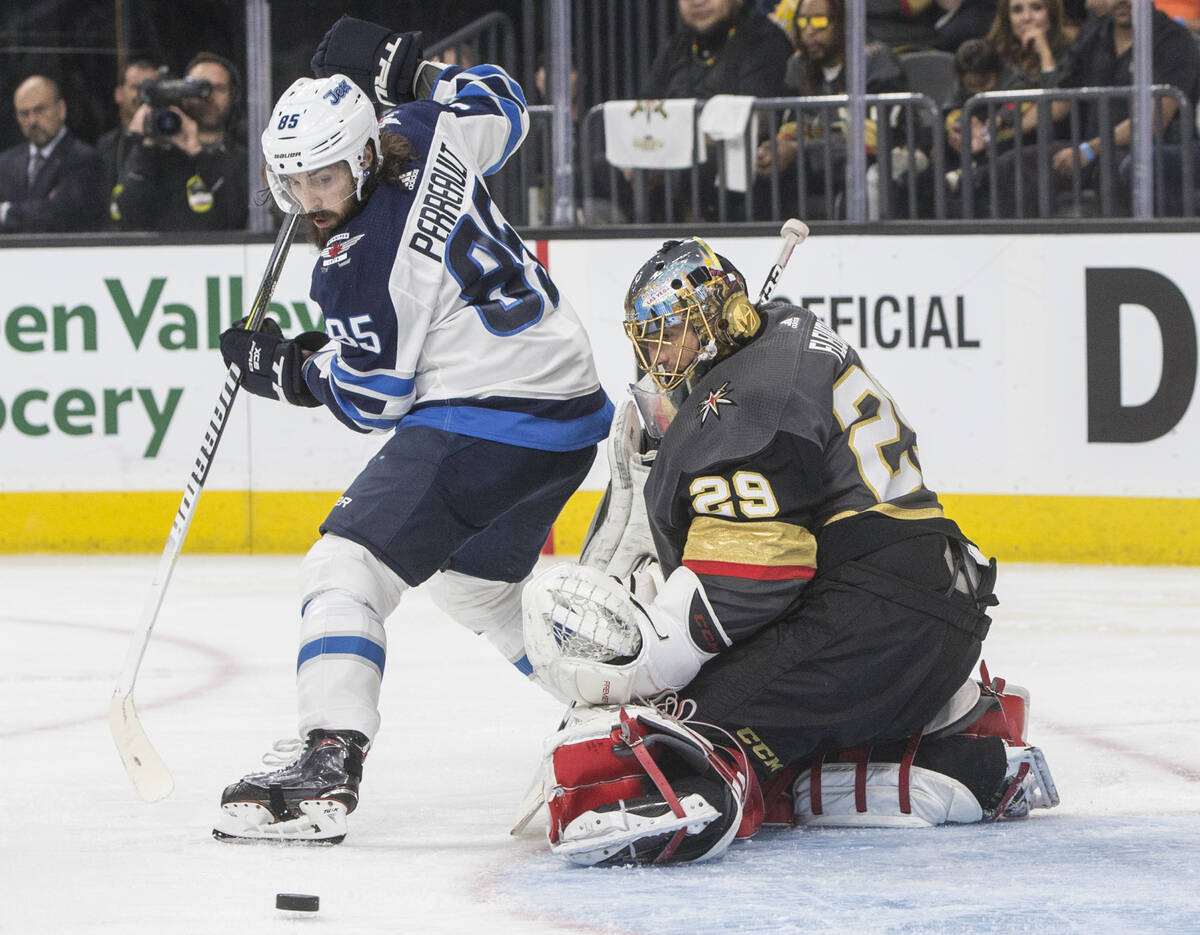 Golden Knights goaltender Marc-Andre Fleury (29) makes a save against Jets center Mathieu Perre ...
