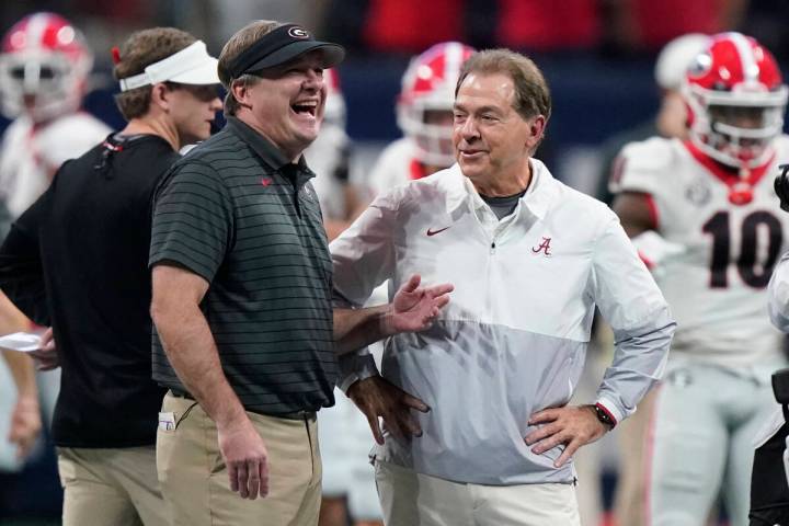 Georgia coach Kirby Smart speaks with Alabama coach Nick Saban before the first half of the Sou ...