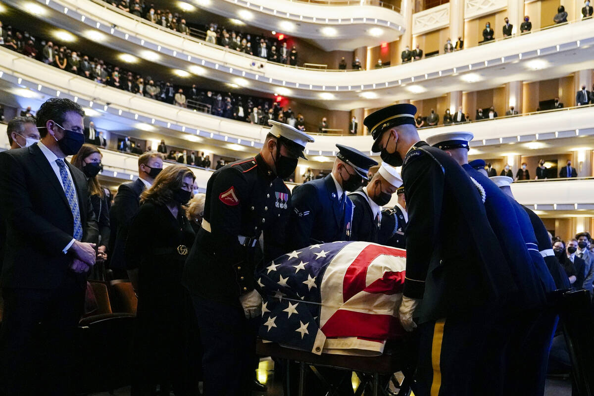 A military honor guard moves the flag-draped casket of former Senate Majority Leader Harry Reid ...