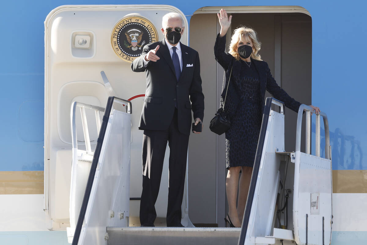 President Joe Biden and first lady Jill Biden wave as they board Air Force One upon departure a ...