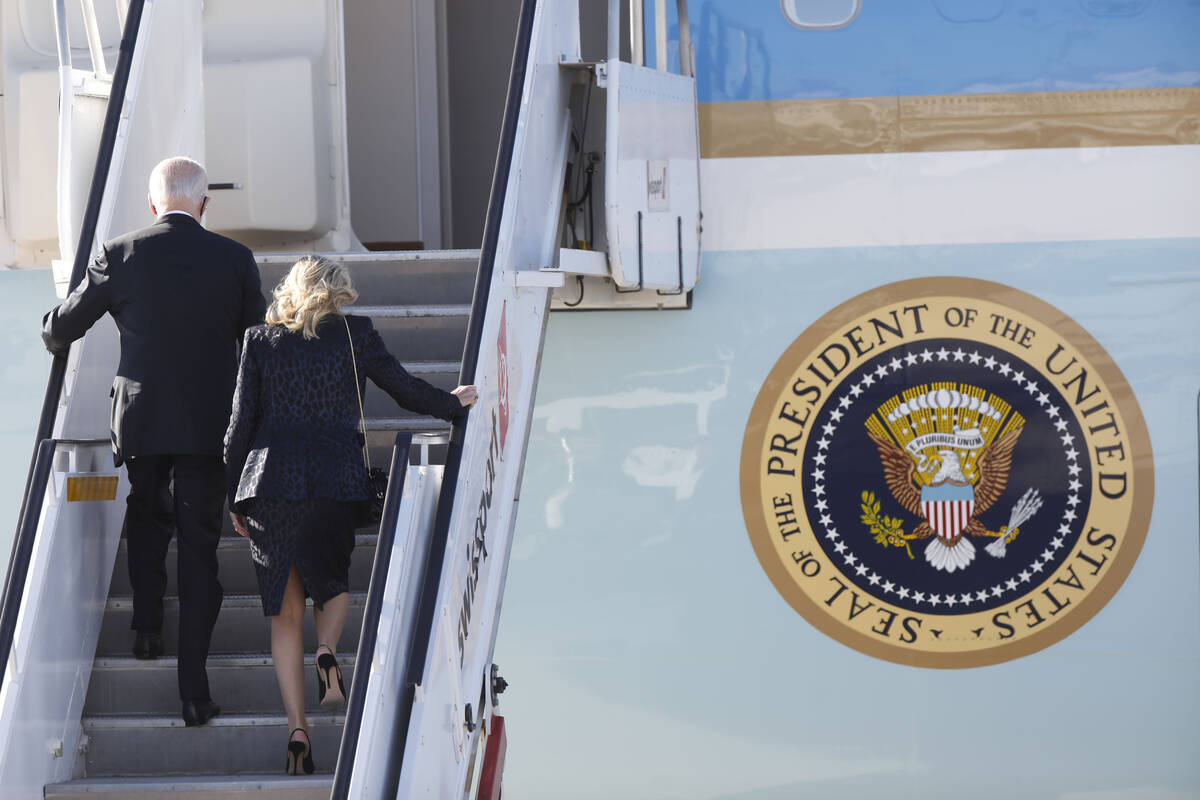 President Joe Biden and first lady Jill Biden climb the stairs as they board Air Force One upon ...