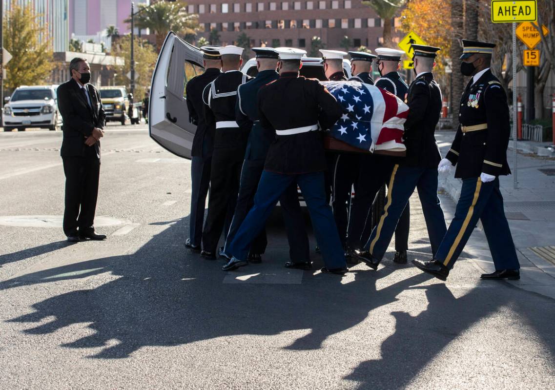 A military honor guard carries the flag-draped casket of former U.S. Sen. Harry Reid out of The ...