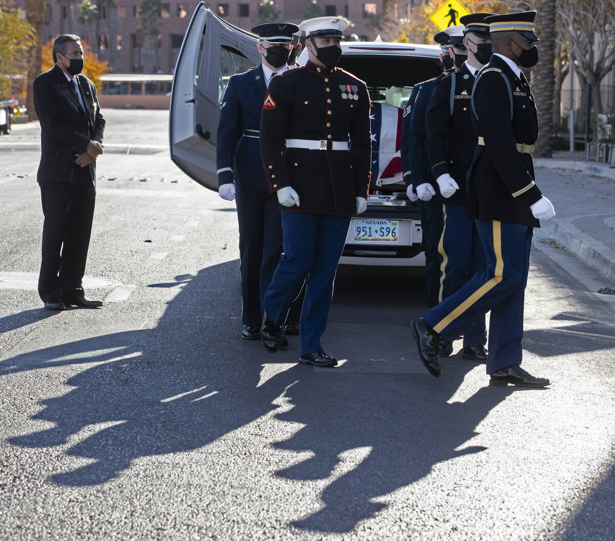 A military honor guard carries the flag-draped casket of former U.S. Sen. Harry Reid out of The ...