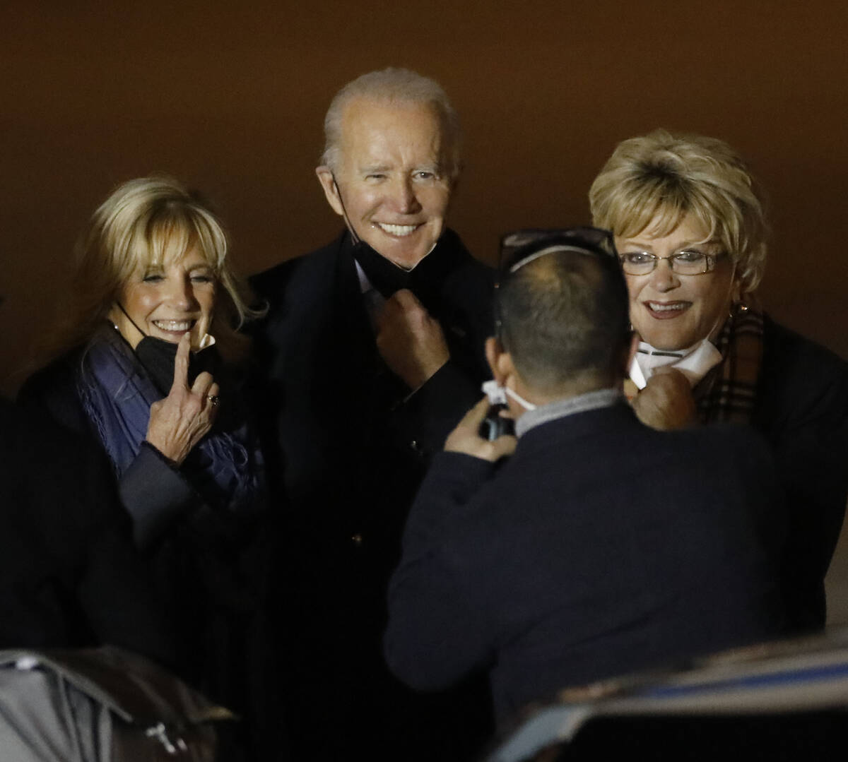 President Joe Biden, center, takes photos with first lady Jill Biden, left, and Las Vegas Mayor ...