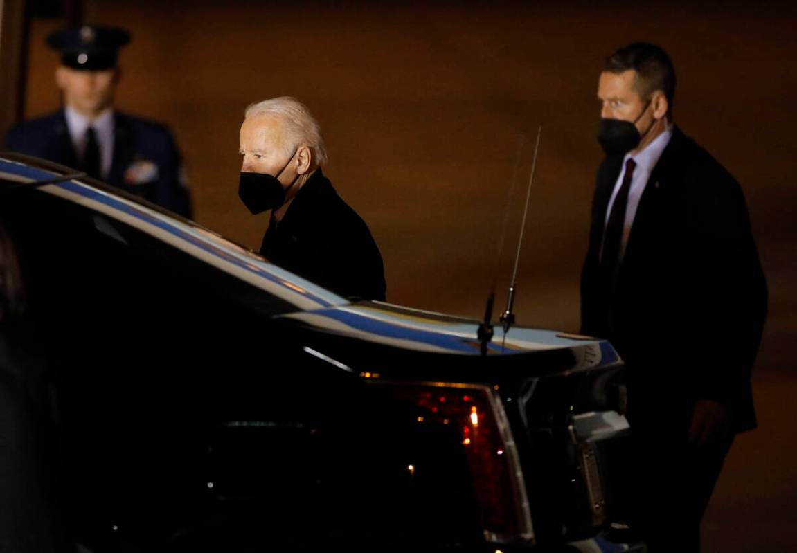 President Joe Biden, center, walks to a car after he arrived on Air Force One at Harry Reid Int ...