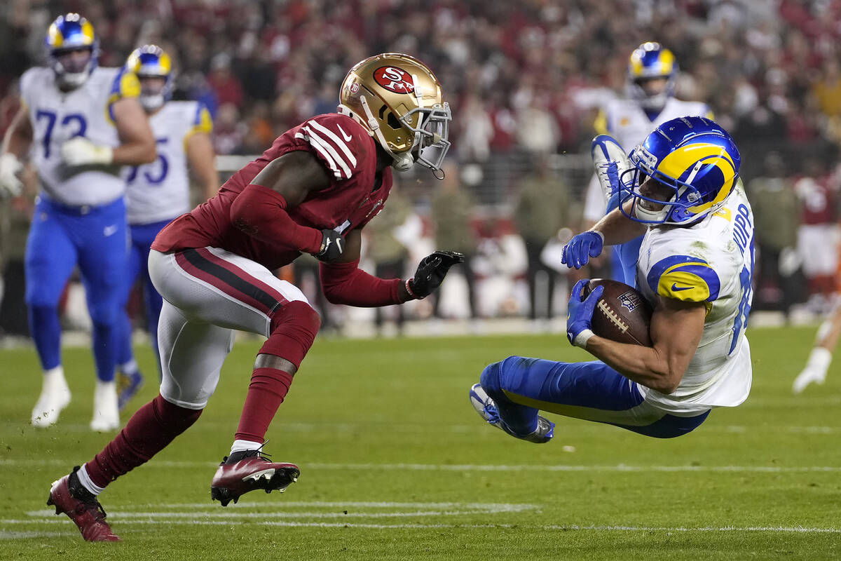 Los Angeles Rams wide receiver Cooper Kupp, right, is tackled in front of San Francisco 49ers c ...