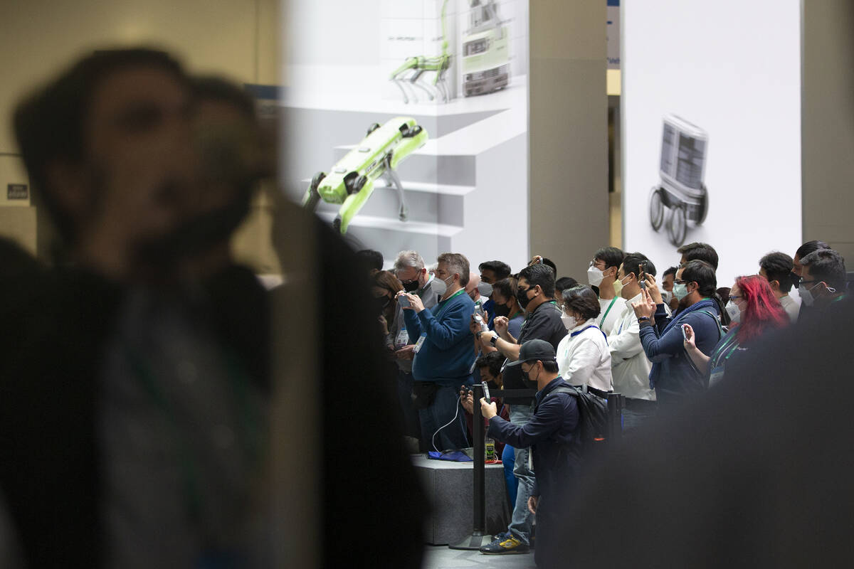 A crowd watches a robotic demonstration at the Hyundai Robotics display during the third day of ...