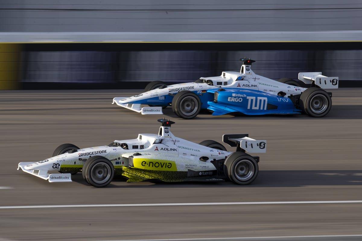 Teams TUM Autonomous Motorsport, top, and PoliMOVE, race in the final of the Indy Autonomous Ch ...