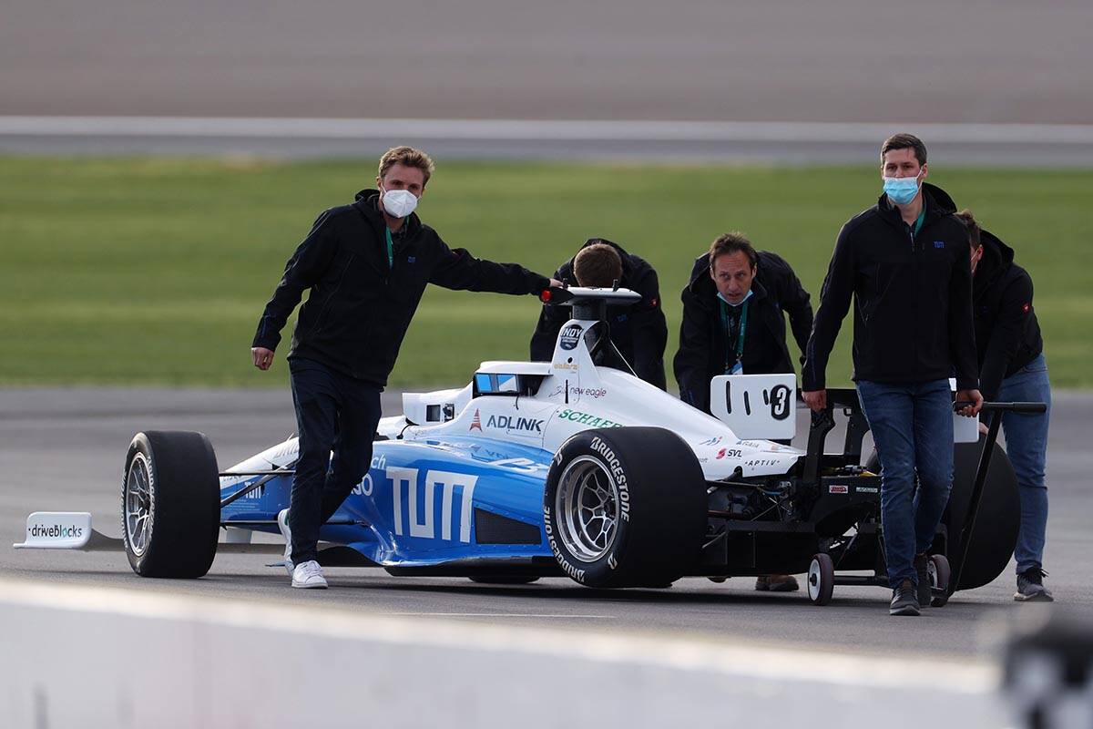 Members of the TUM Autonomous Motorsport team retrieve their autonomous vehicle after winning i ...