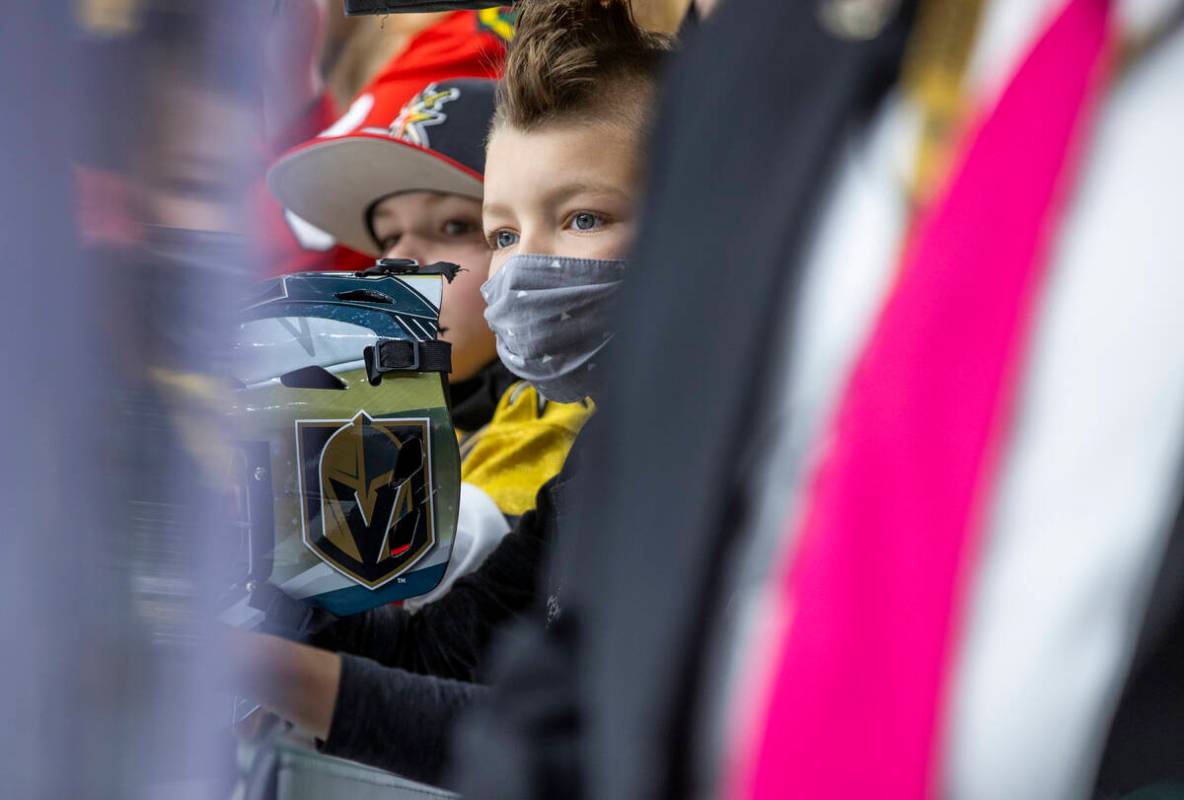 Young Golden Knights fans look to players during warm ups before the first period of an NHL gam ...