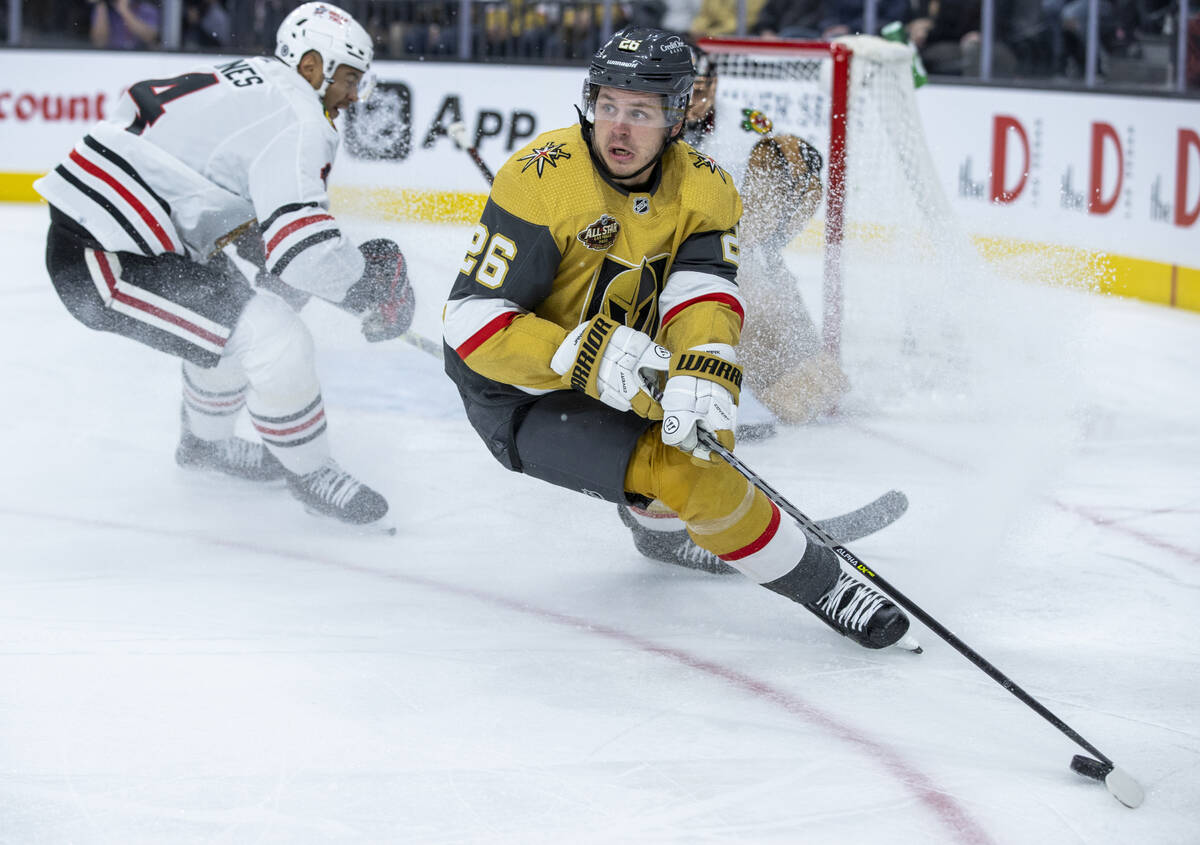 Golden Knights center Mattias Janmark (26) looks to pass the puck while avoiding Chicago Blackh ...