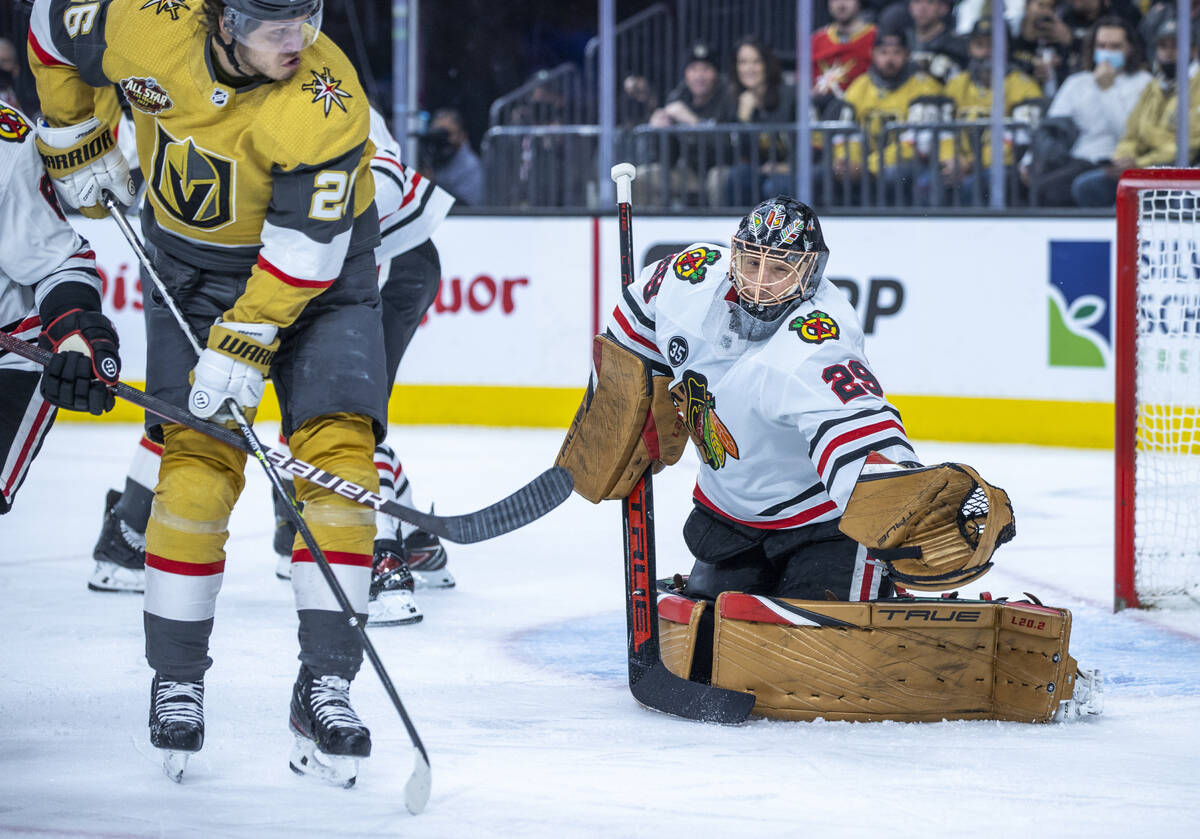 Golden Knights center Mattias Janmark (26) sends a puck towards the net defended by Chicago Bla ...