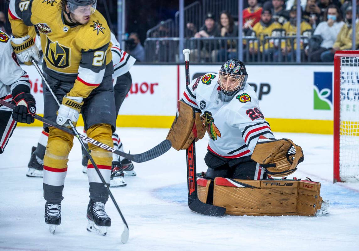 Golden Knights center Mattias Janmark (26) sends a puck towards the net defended by Chicago Bla ...