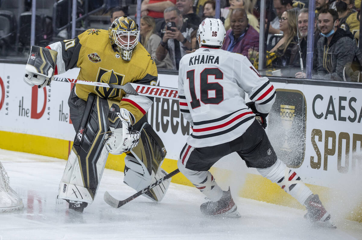 Golden Knights goaltender Robin Lehner (90) sends the puck on past Chicago Blackhawks left wing ...