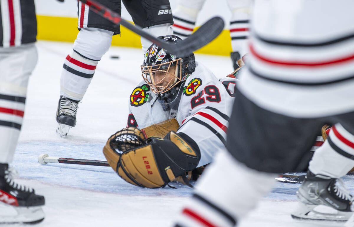 Chicago Blackhawks goaltender Marc-Andre Fleury (29) dives on a puck during warm ups before the ...