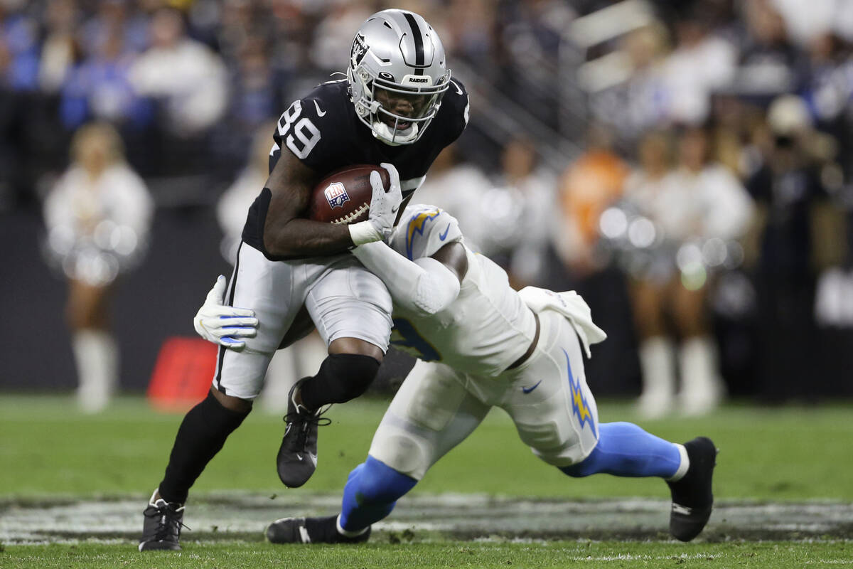 Los Angeles Chargers middle linebacker Kenneth Murray (9) tackles Las Vegas Raiders wide receiv ...