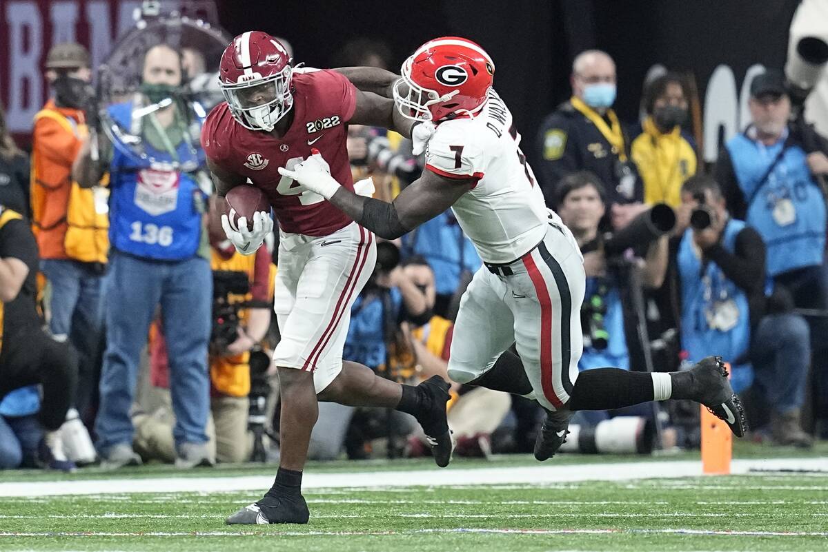 Alabama's Brian Robinson Jr. runs for a first down past Georgia's Quay Walker during the second ...