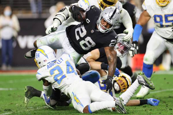 Raiders running back Josh Jacobs (28) runs the ball against the Los Angeles Chargers in the sec ...