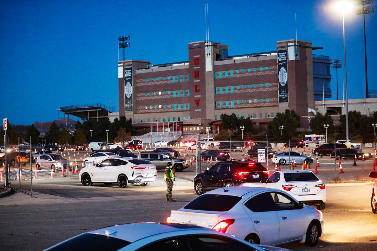 People wait in line for the COVID-19 testing and vaccine clinic at Sam Boyd Stadium on Sunday, ...