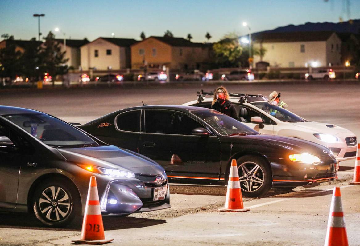 People wait in line for the COVID-19 testing and vaccine clinic at Sam Boyd Stadium on Sunday, ...