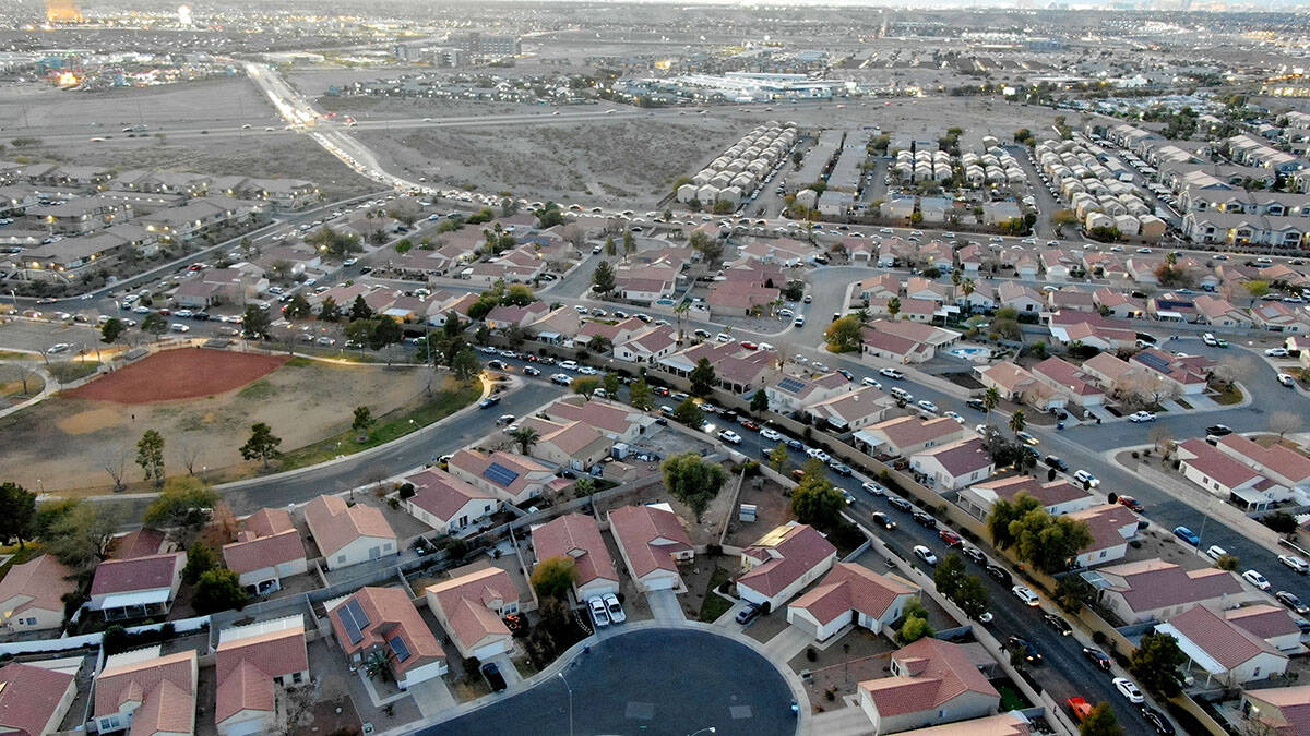 Cars snake through residential neighborhoods as they line up for the drive-thru COVID testing s ...