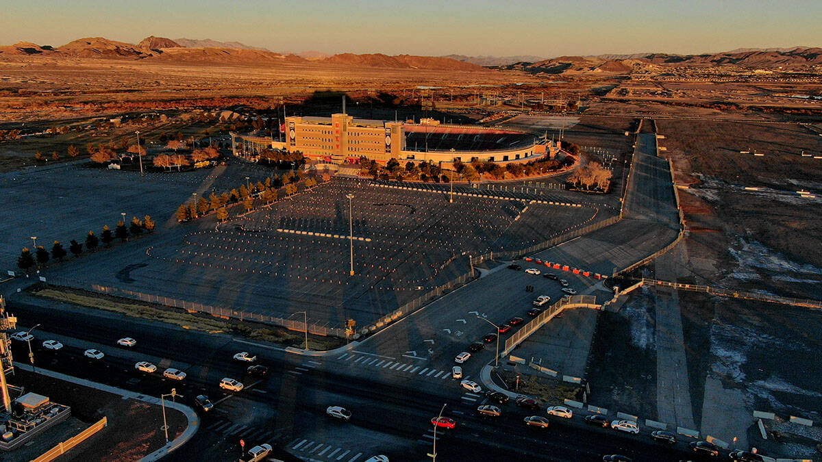 An aerial view of Sam Boyd Stadium as cars line up down South Broadbent Boulevard for the drive ...