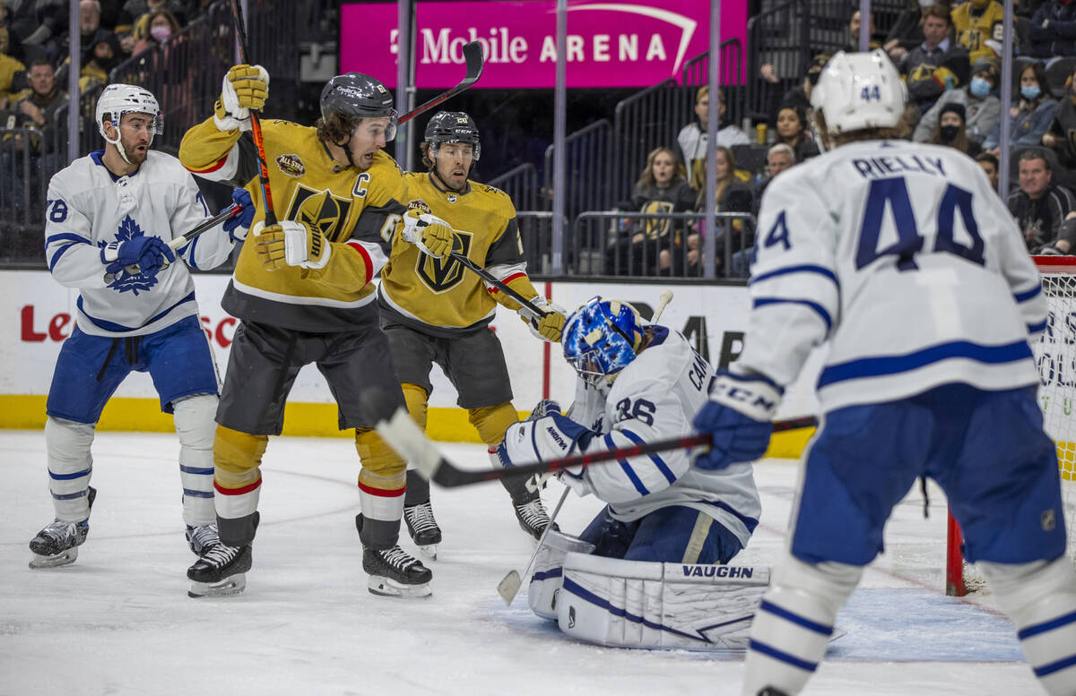 Golden Knights right wing Mark Stone (61) reacts with center Chandler Stephenson (20) as a puck ...